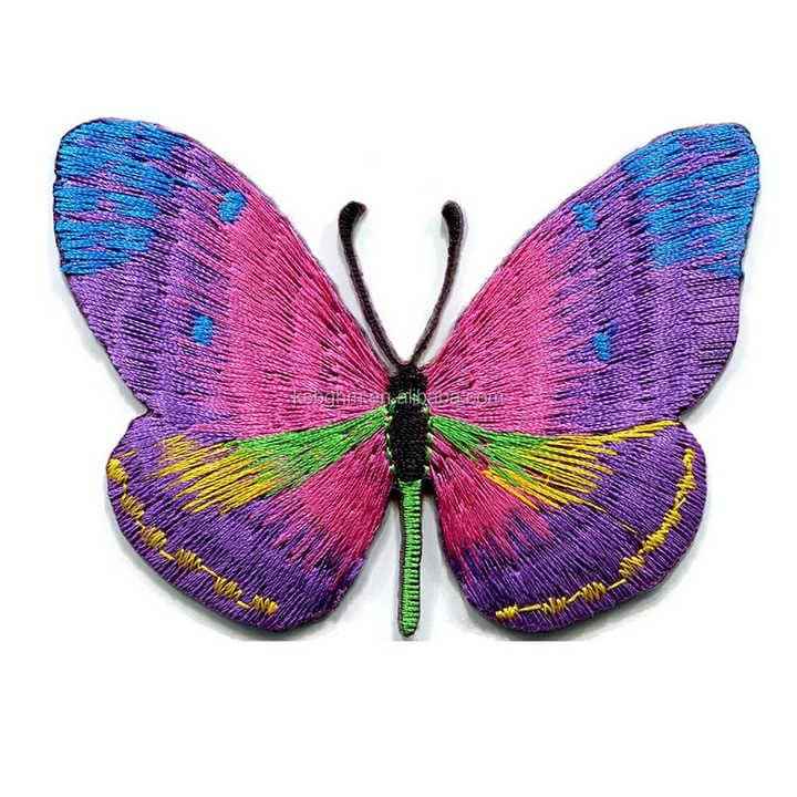 Custom embroidered vibrant butterfly patch featuring colorful pink, purple, yellow, and green wing segments with a black body.