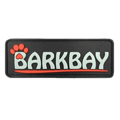Custom black rectangular PVC patch featuring a raised red paw print and the text 