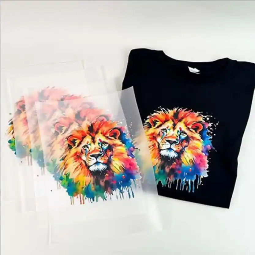 Custom DTF transfer sheet displaying a vibrant watercolor lion design next to a black t-shirt featuring the pressed lion graphic.