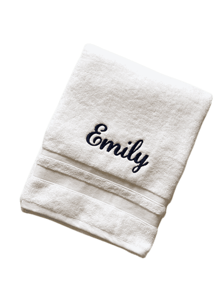 Custom embroidery digitizing mockup featuring a clean white towel embroidered with the custom cursive name 