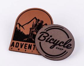 Custom engraved leather Adventure Awaits and Bicycle Shop logo patches