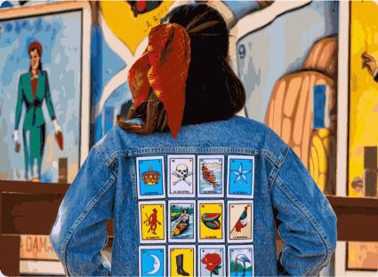 Custom embroidered Loteria card patches stitched on back of a denim jacket
