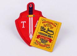 Custom embroidered red sword shield patch and yellow Blue Jeans label patch